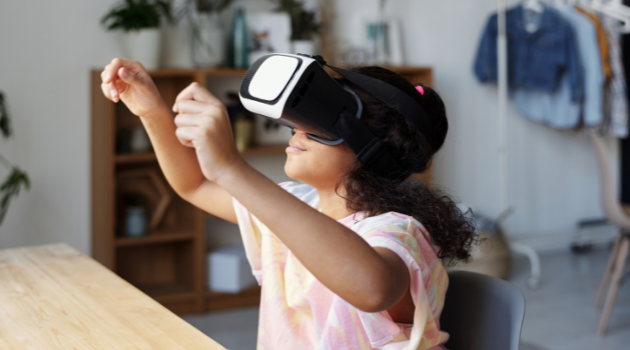 young girl wearing a vr headset with her hands in the air