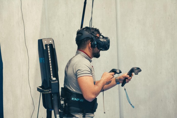 Person in a VR headset using assistive VR hardware.
