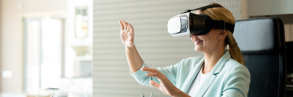 woman wearing a vr headset with her arms in the air