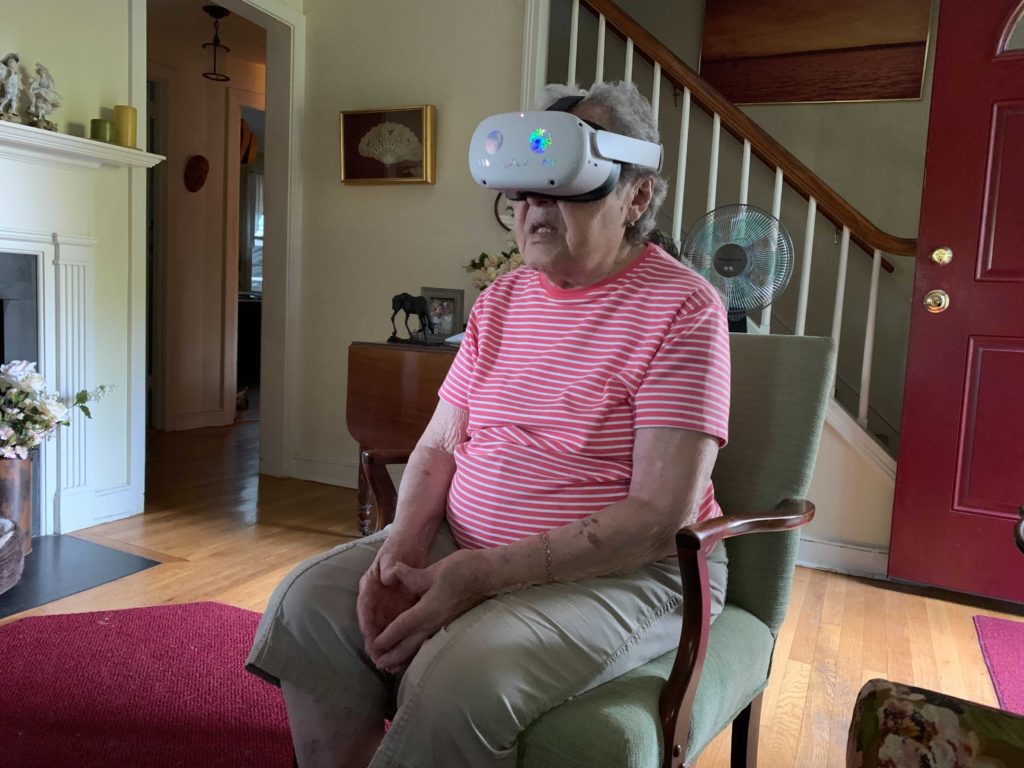a photo of an elderly woman with a vr headset on