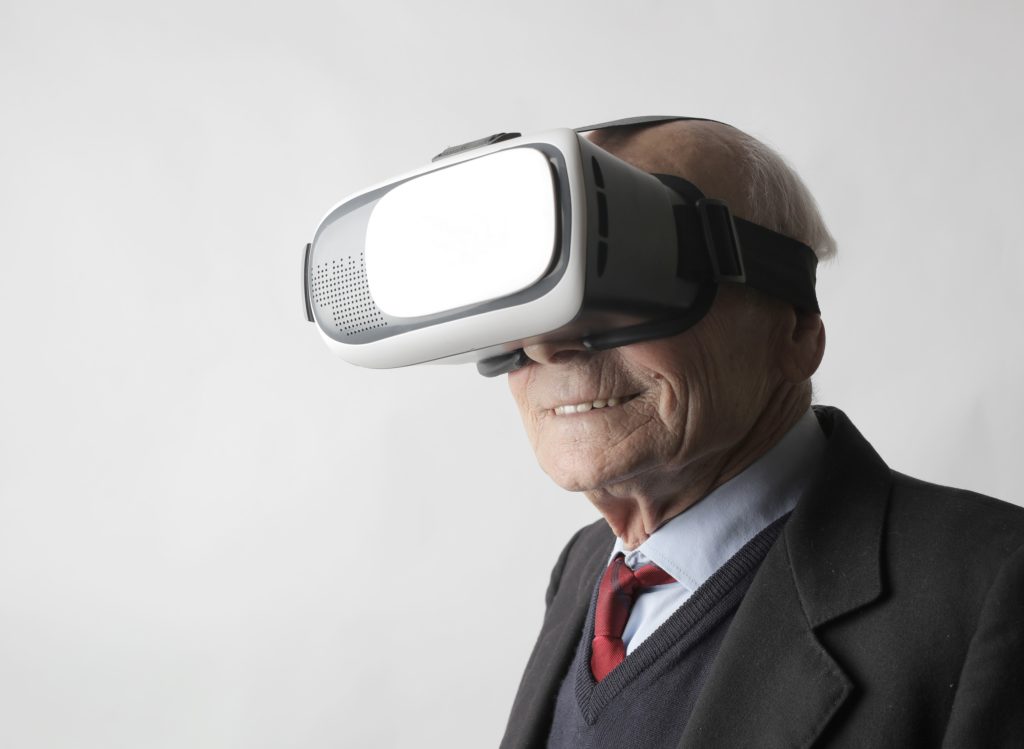 an elderly man with a vr headset on 