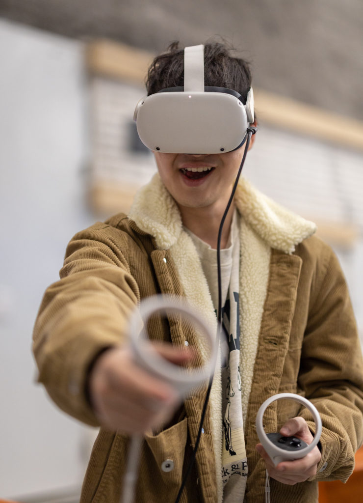 A person wearing a VR headset smiling